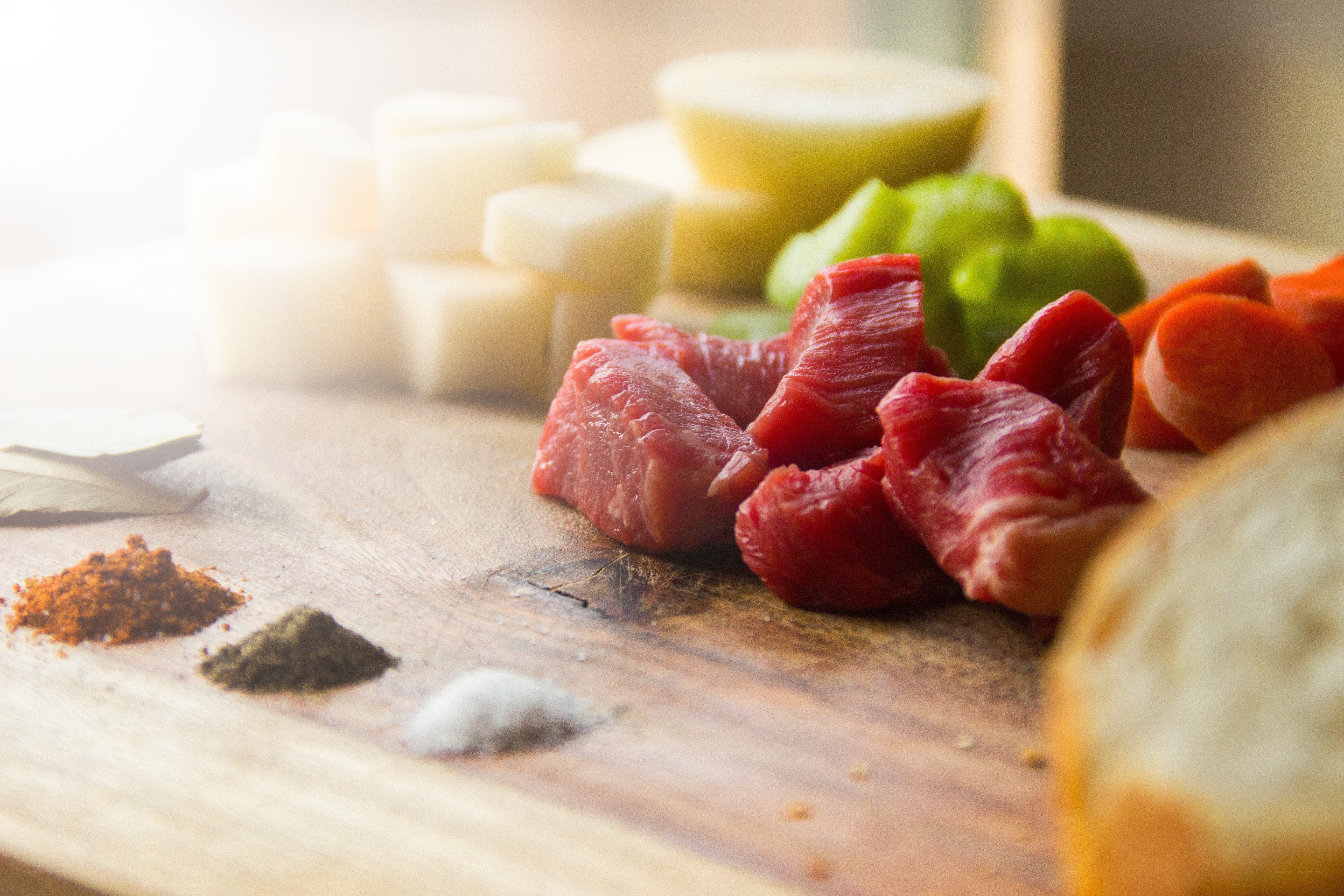 Raw meat and vegetables on cutting board