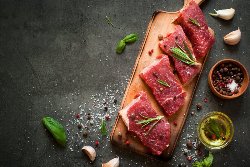 Raw Meat on Cutting Board — Brown