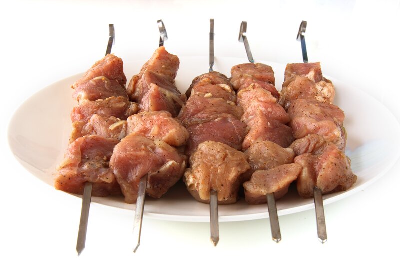 raw meat skewers on plate