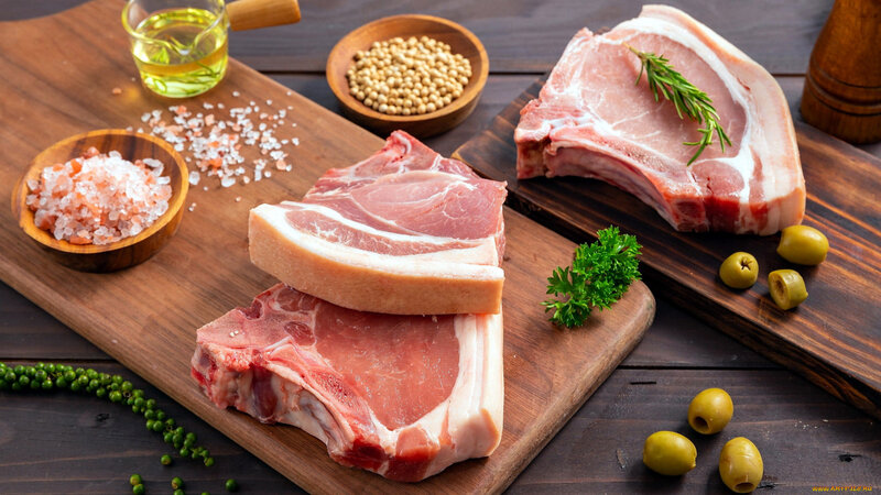 Raw Pork Chops on Wood
