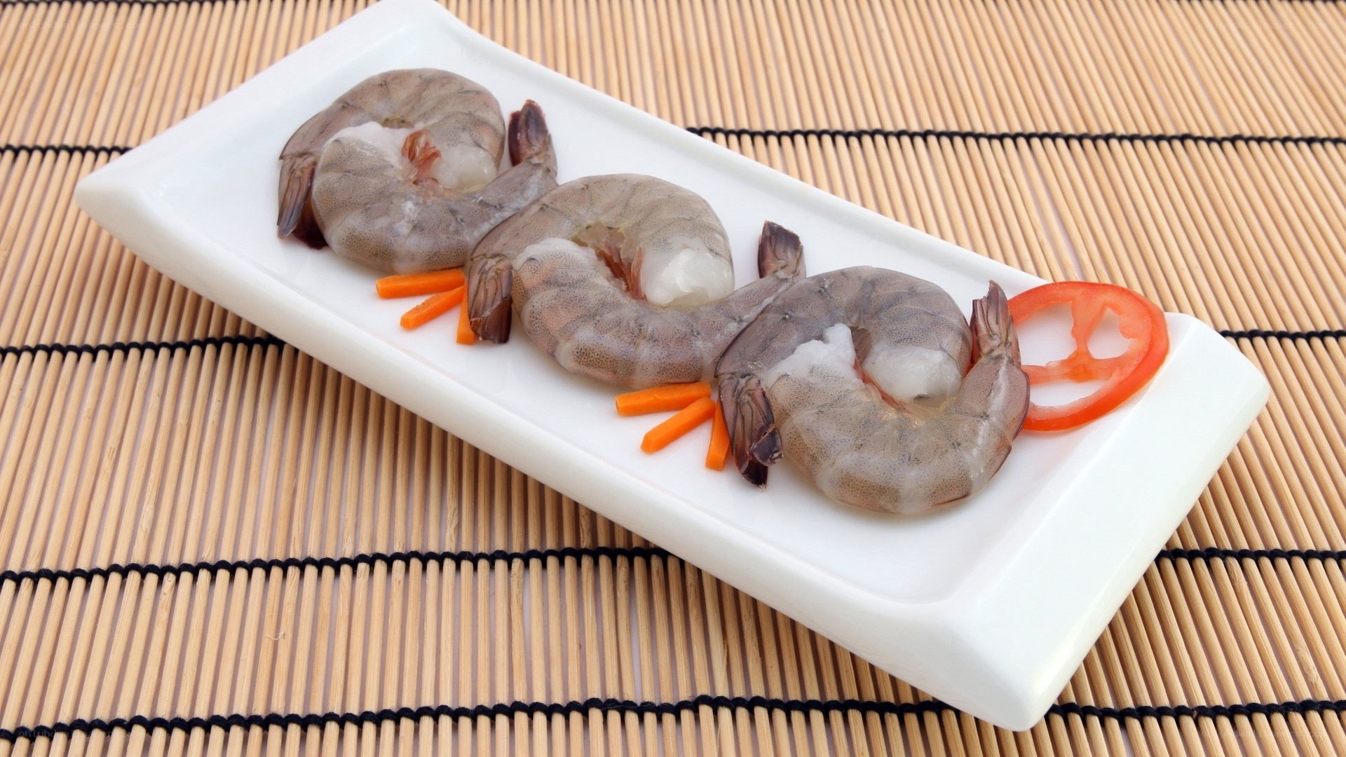 Raw shrimp on a white plate
