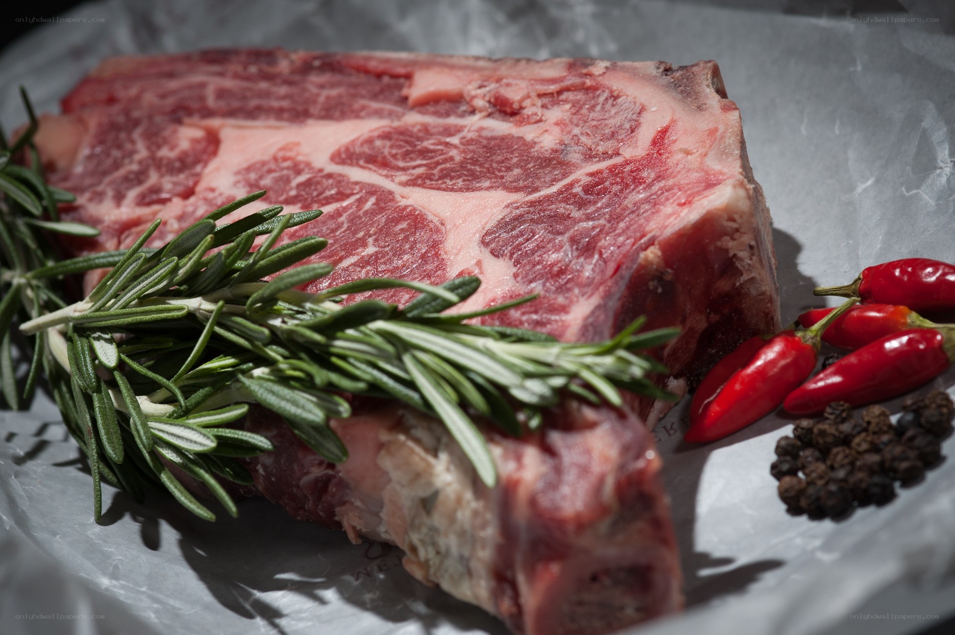 Raw steak with herbs and spices