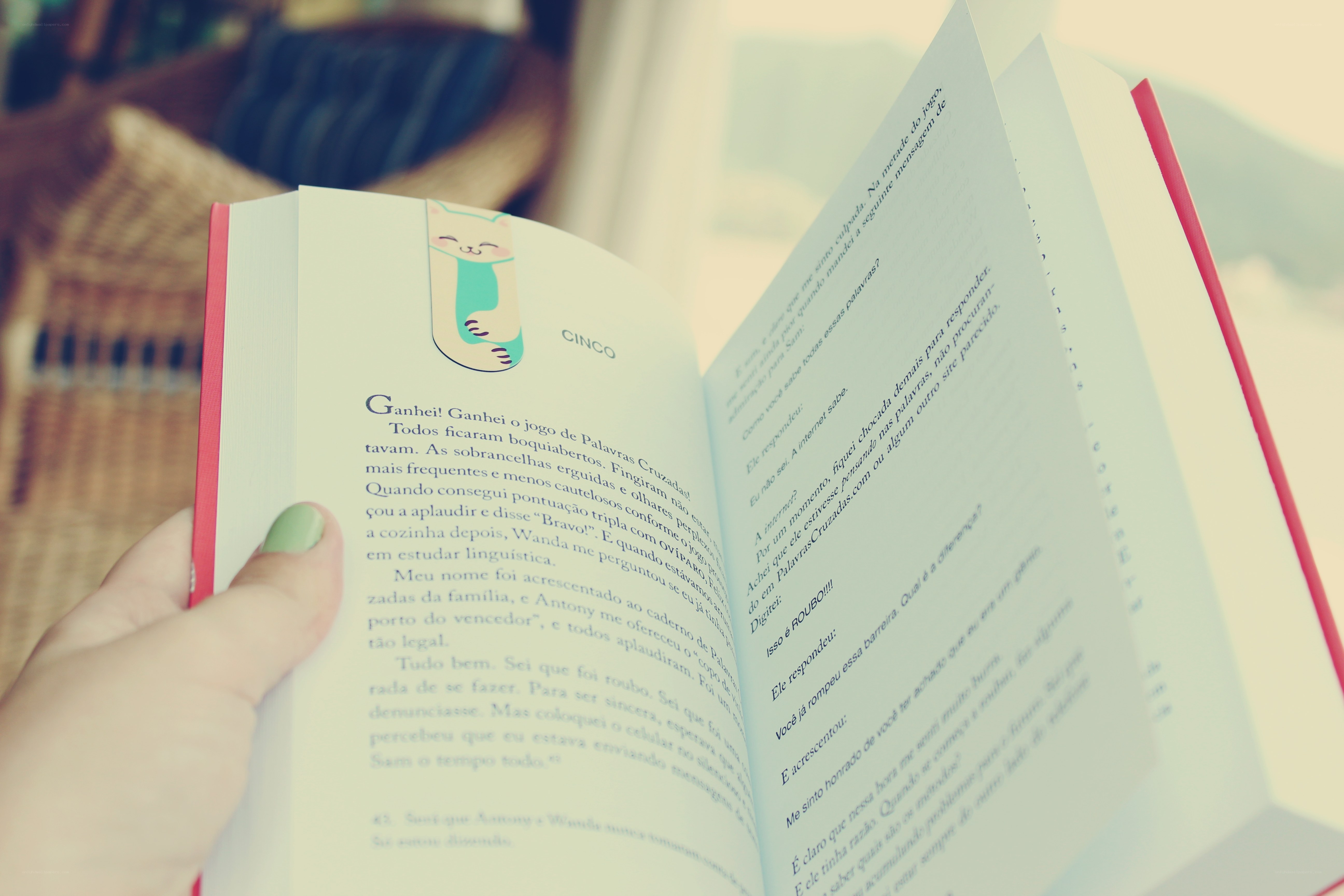 reading a book with a cat bookmark