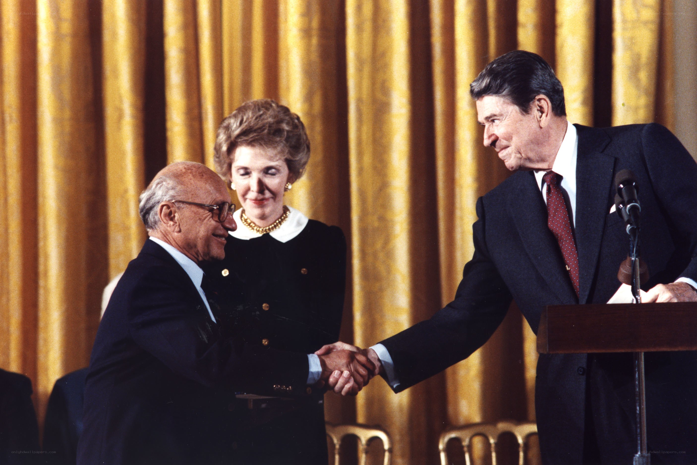 Reagan shaking hands with a man