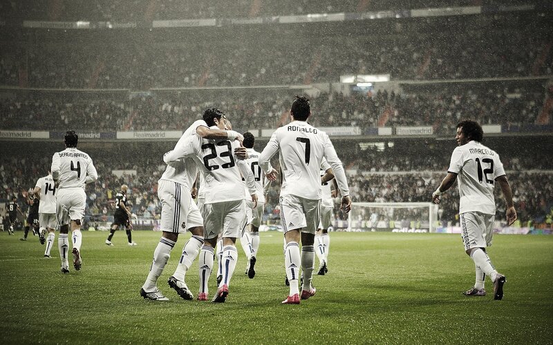Real Madrid players celebrating in rain