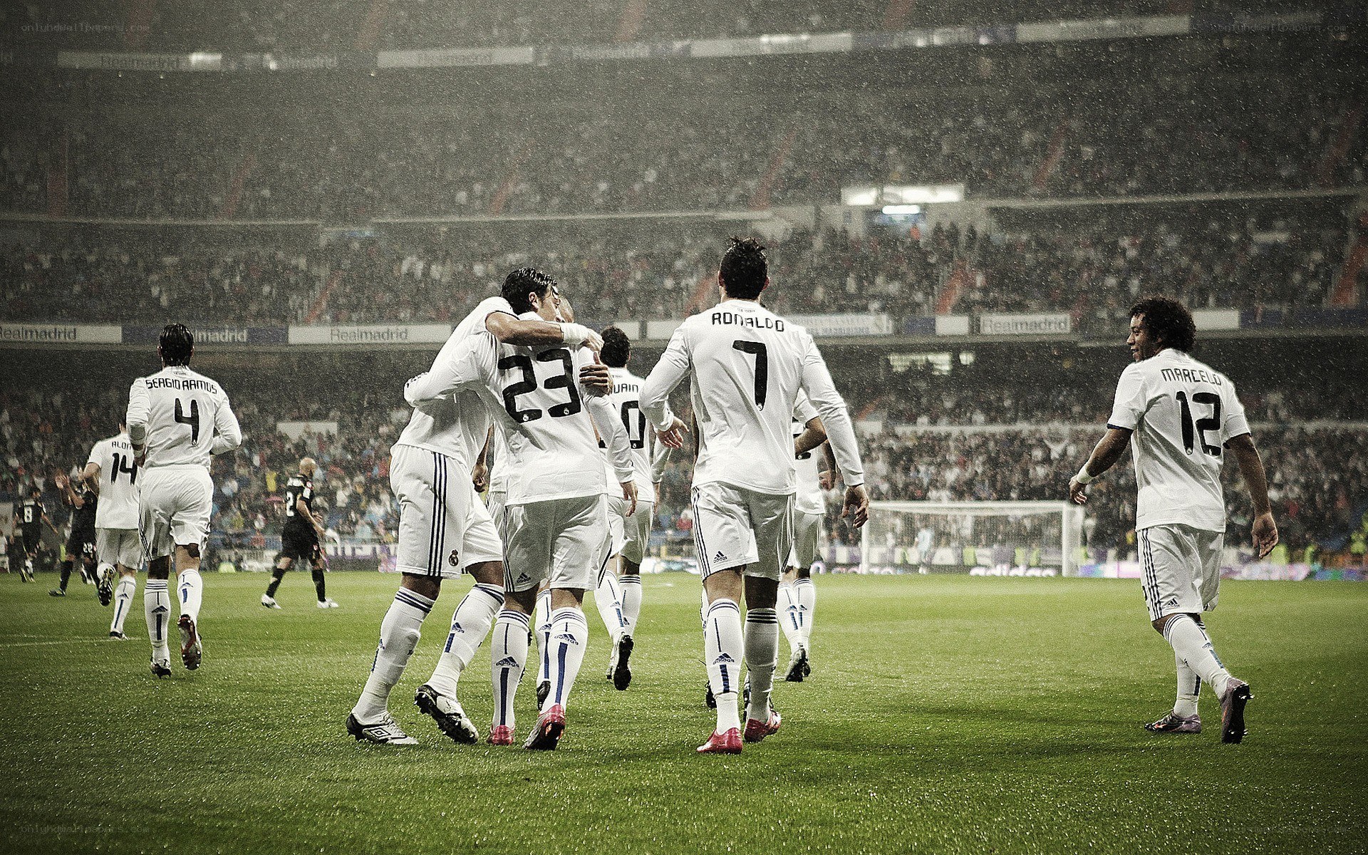Real Madrid players celebrating in rain