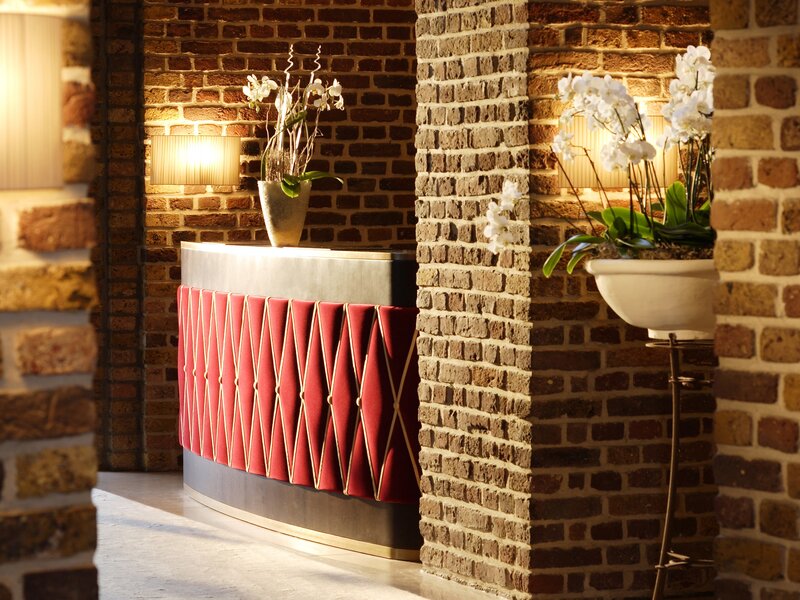 Reception desk with brick wall