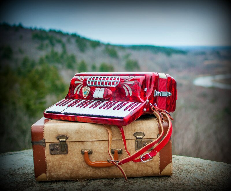 Red Accordion on Suitcase