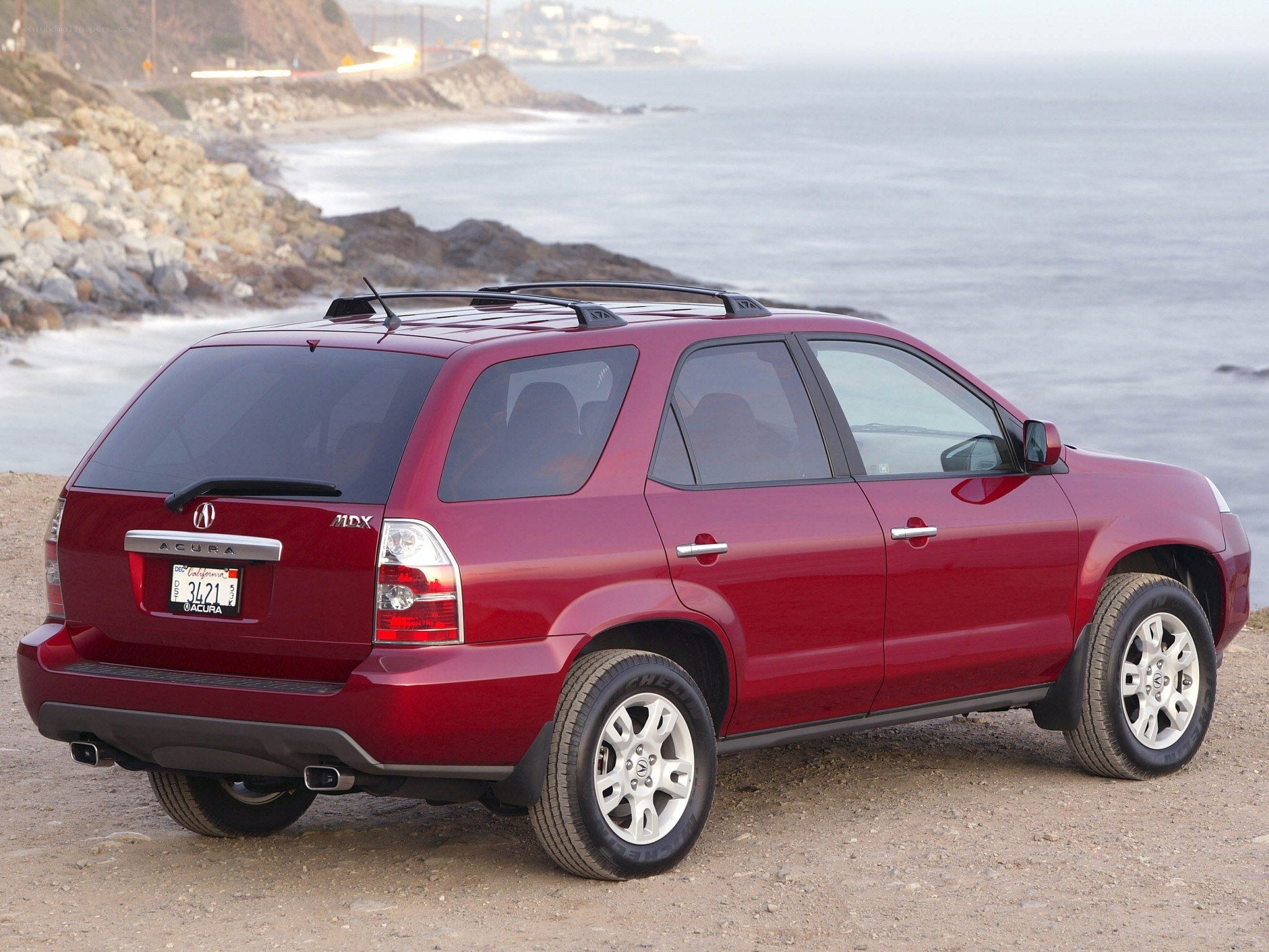 Red Acura MDX by the coast