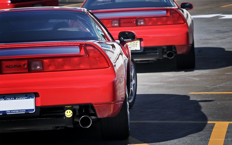 Red Acura NSX cars in parking lot