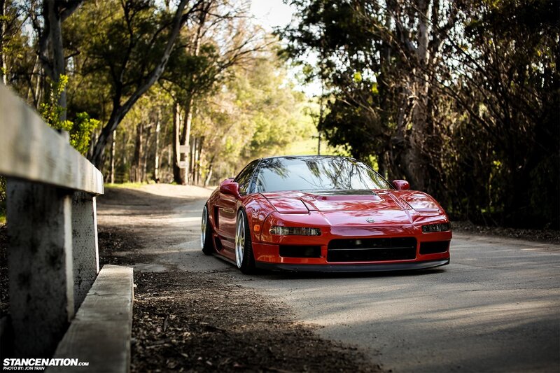 Red Acura NSX on a forest road
