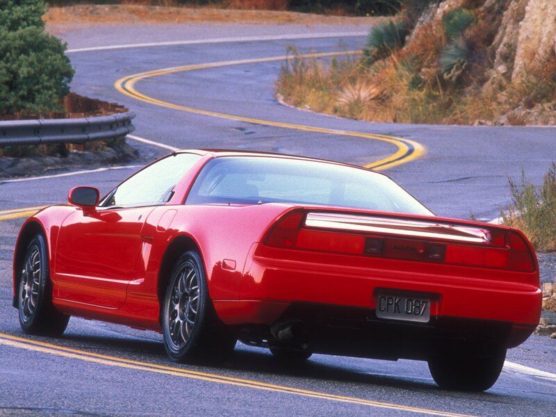Red Acura NSX on winding road