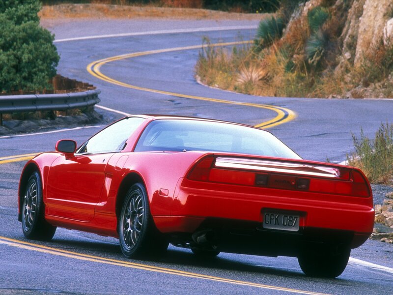 Red Acura NSX on winding road