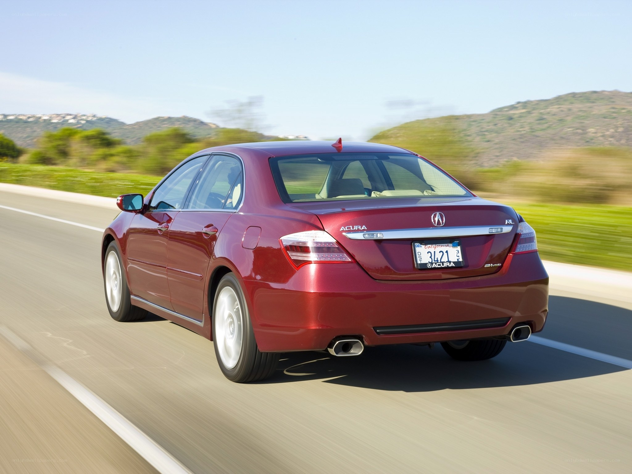 Red Acura RL in motion
