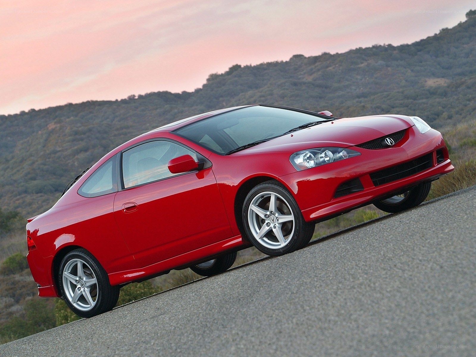 Red Acura RSX on a winding road