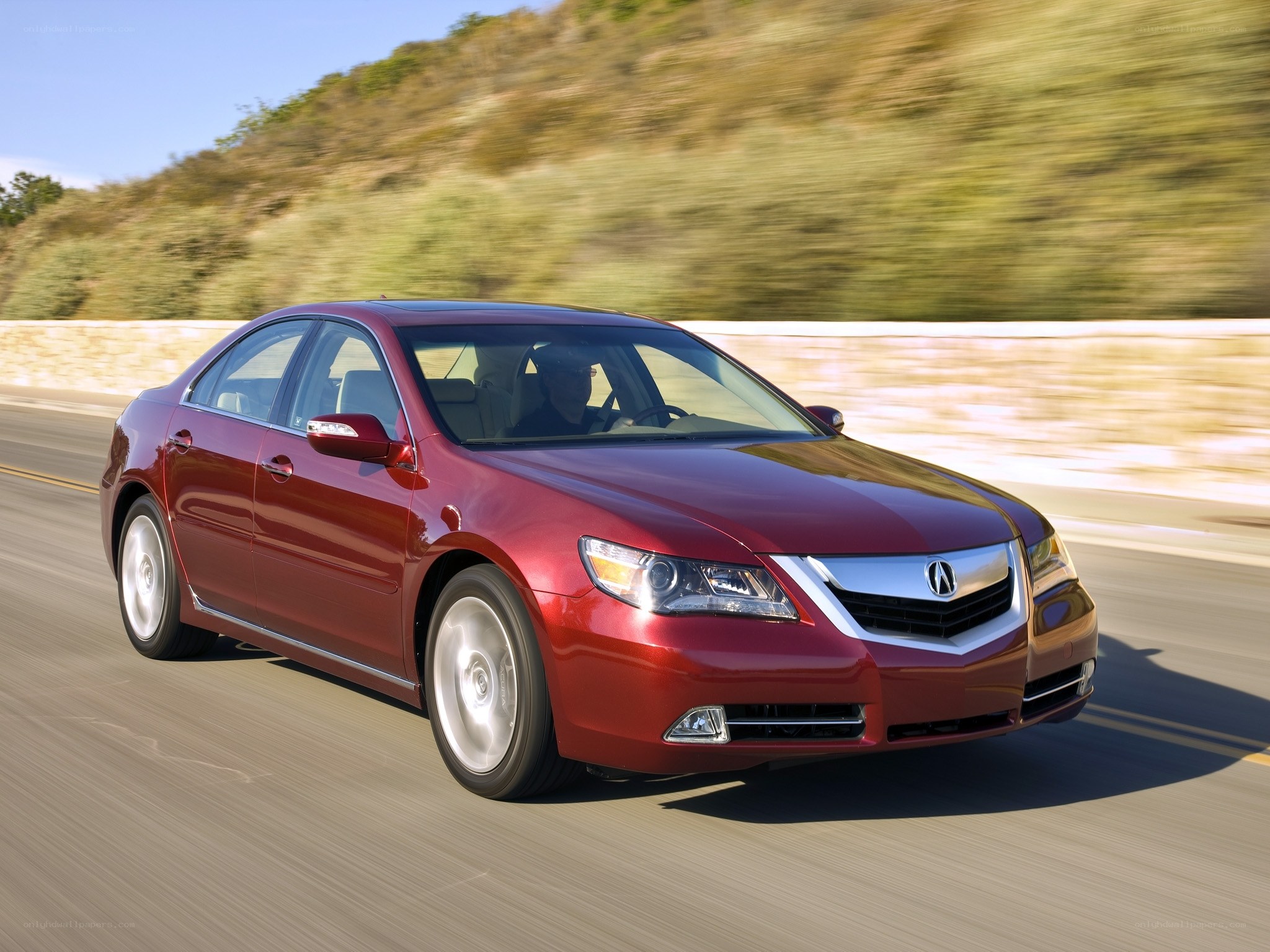 Red Acura TL in motion