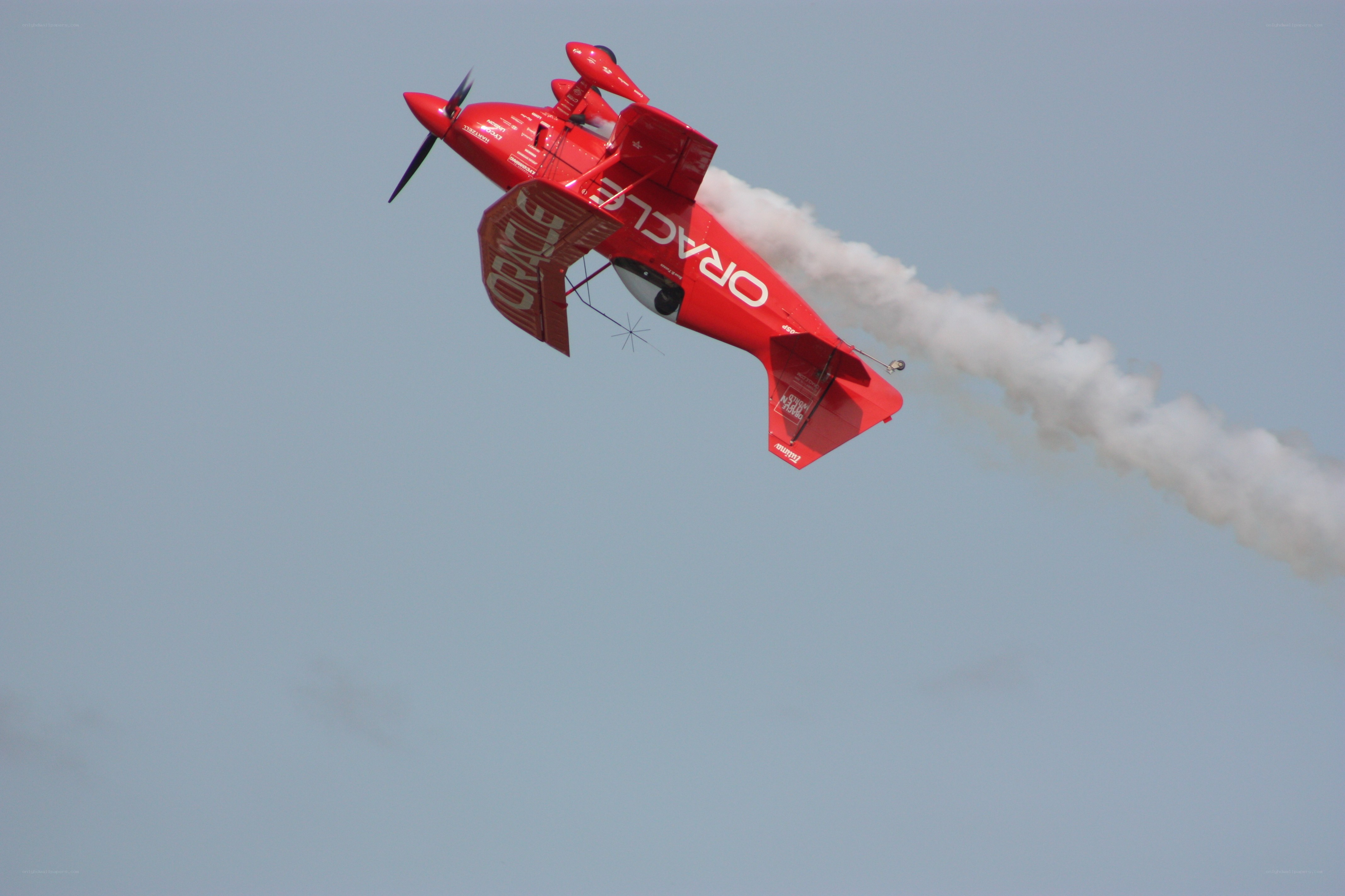Red aerobatic plane in flight