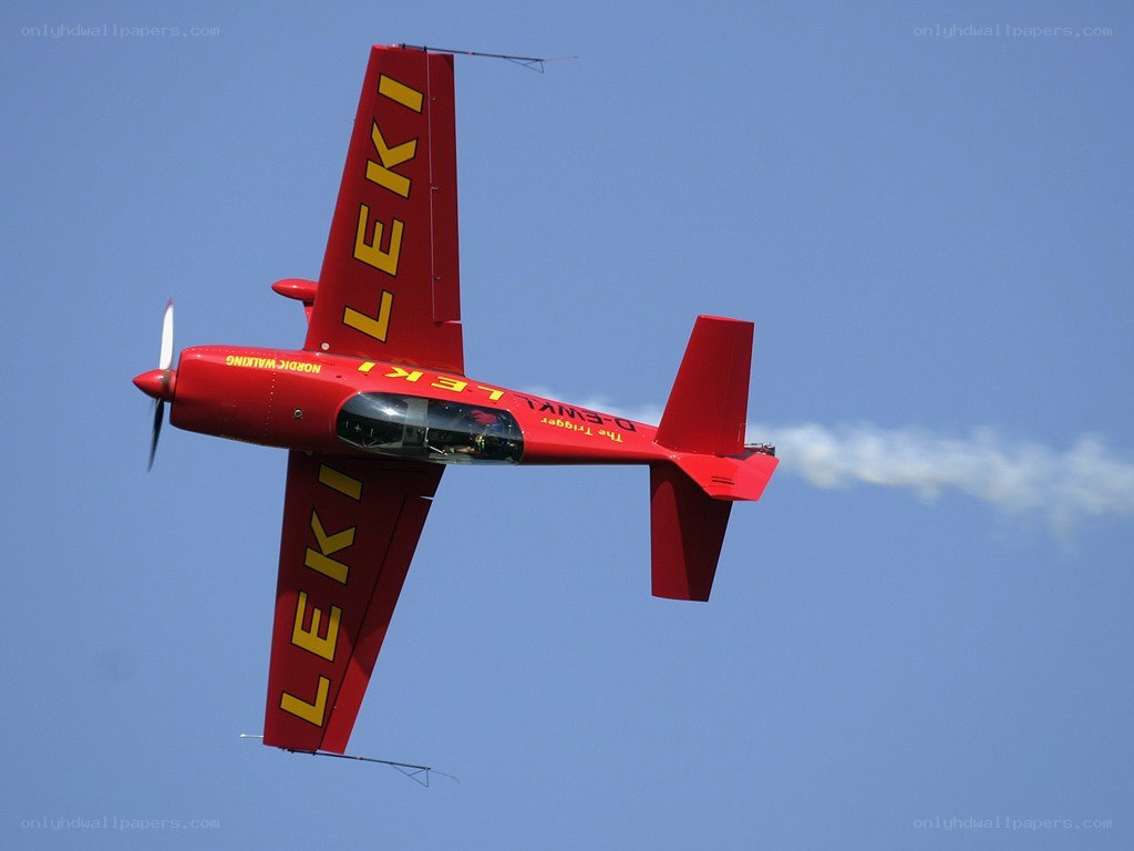 Red aerobatic plane in flight