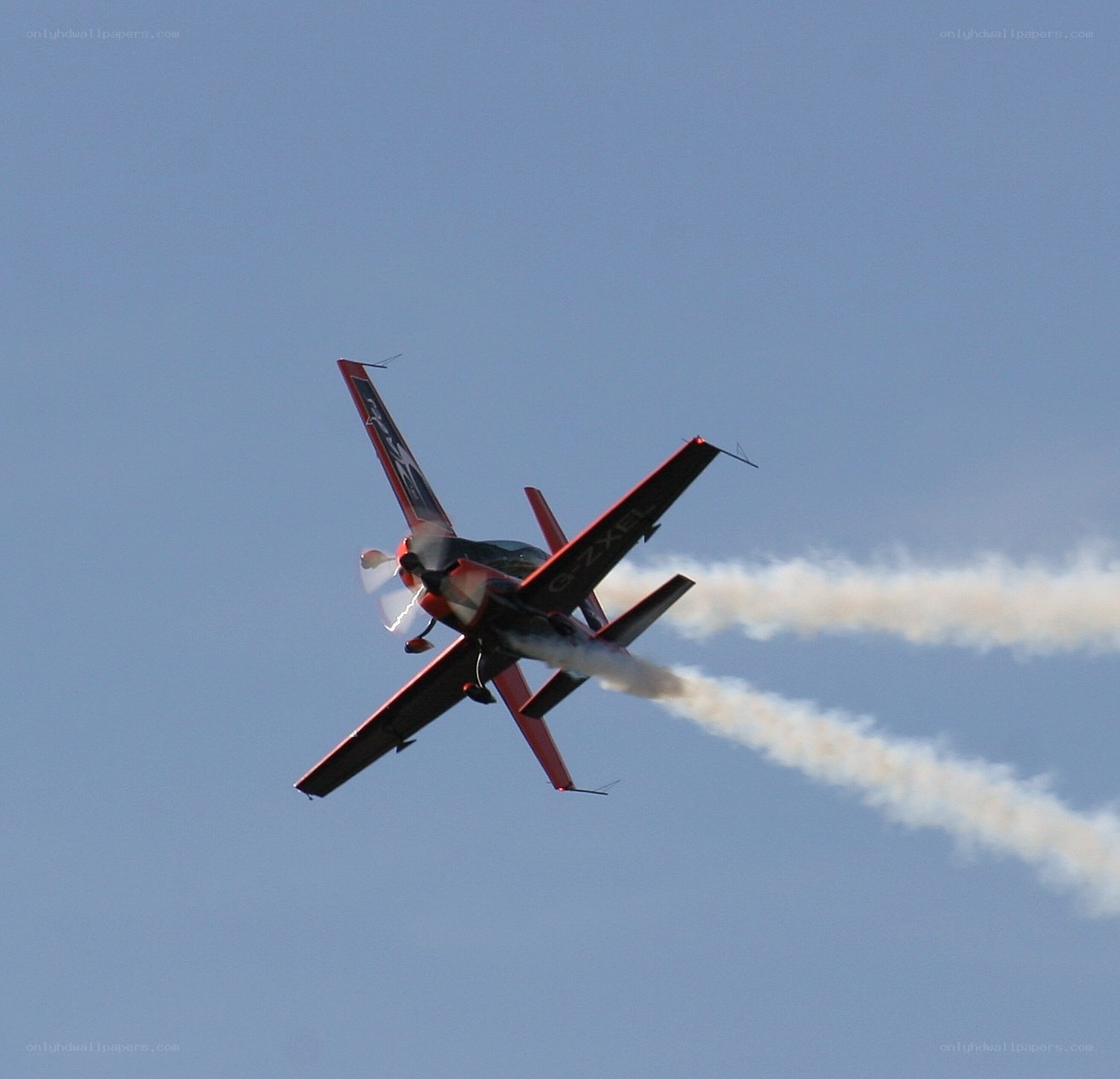 Red aerobatic plane in flight