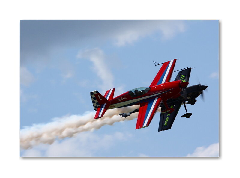 Red aerobatic plane in flight