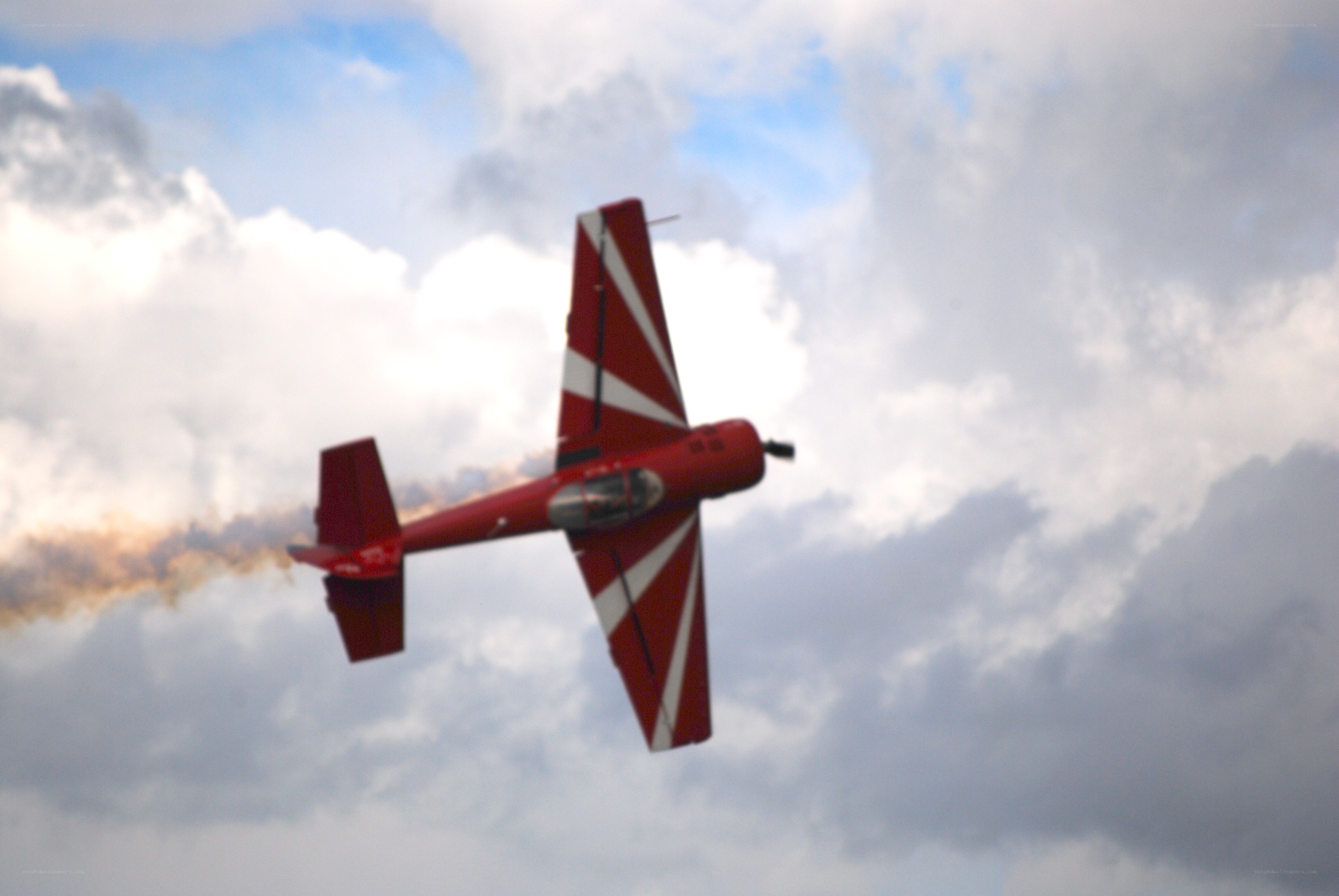 Red aerobatic plane in flight