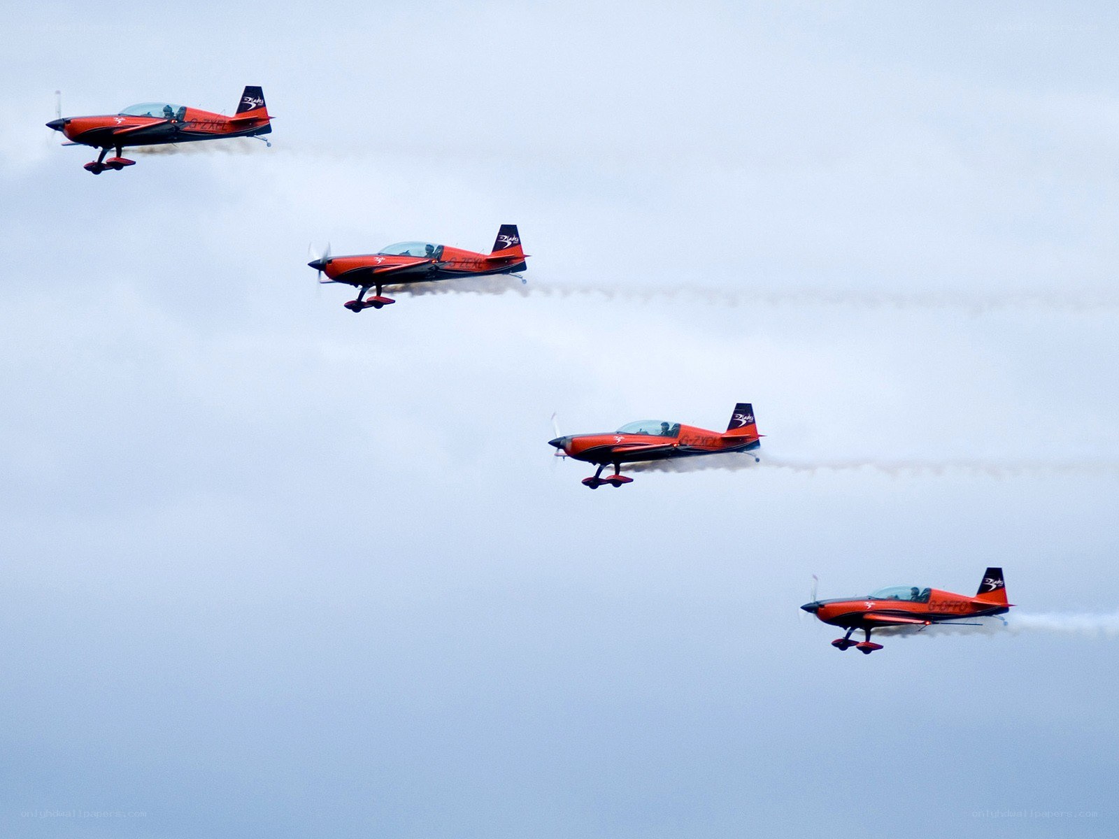 Red aerobatic planes in formation