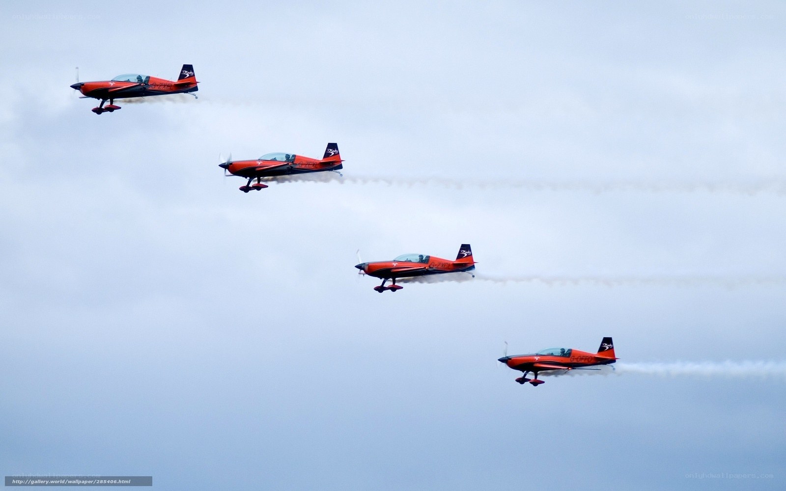 Red aerobatic planes in formation