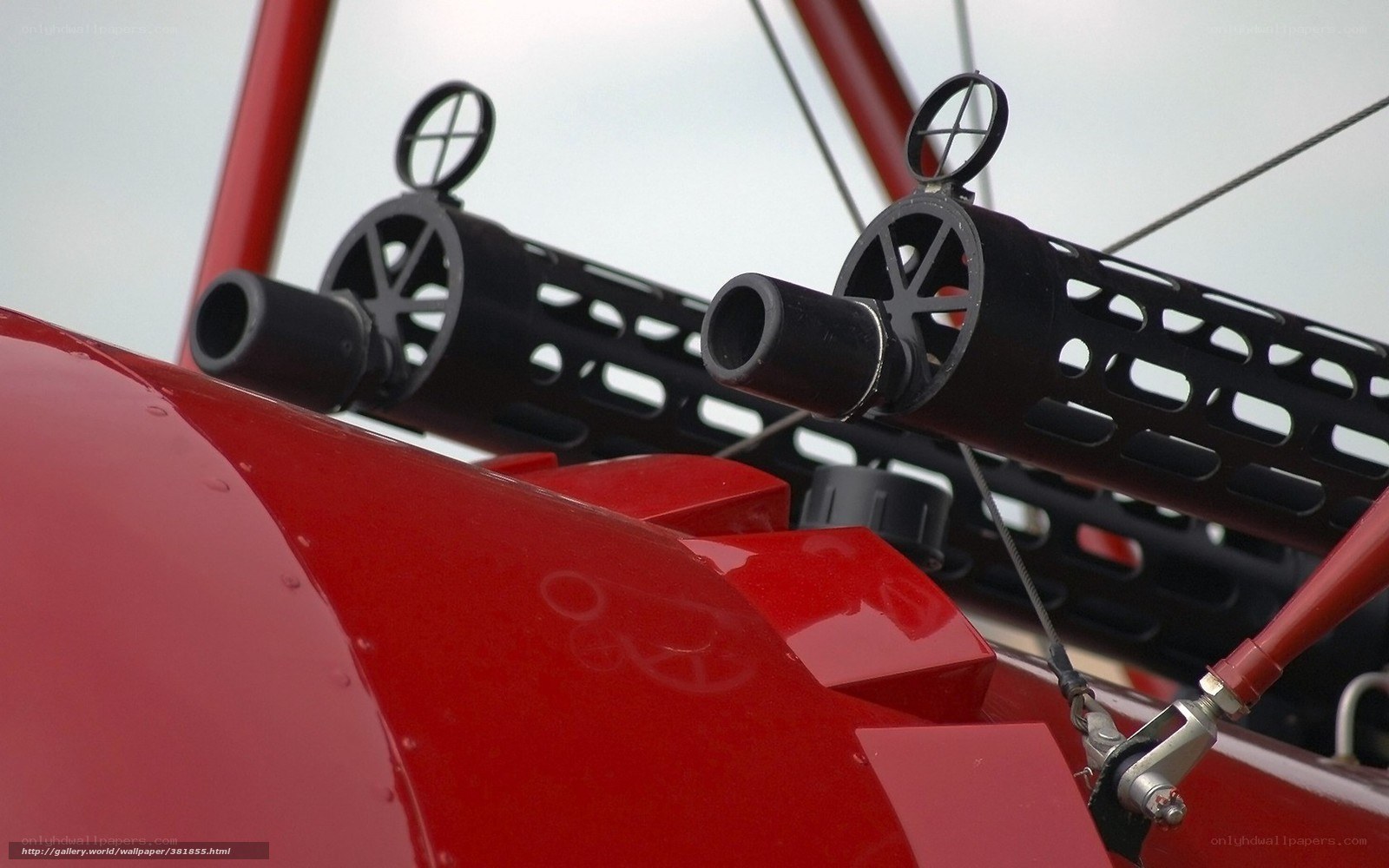 Red aircraft with mounted guns