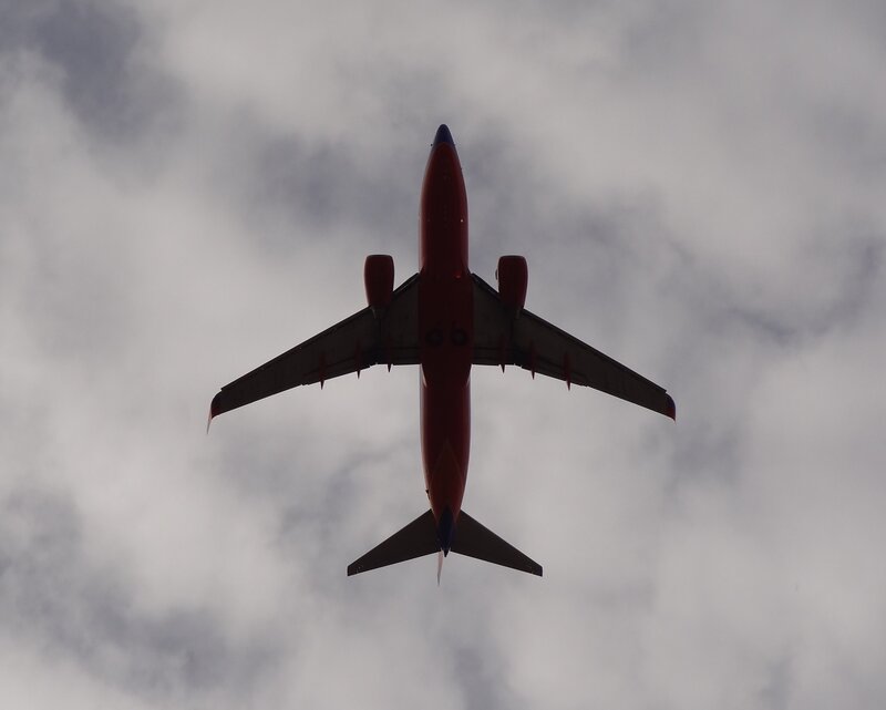 Red Airplane Flying — Dramatic, Photograph