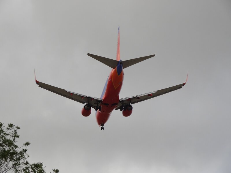 Red Airplane Flying — Overcast