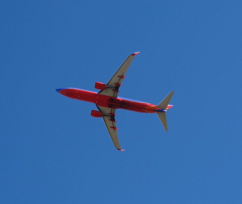 Red Airplane in Flight — Blue, Serene