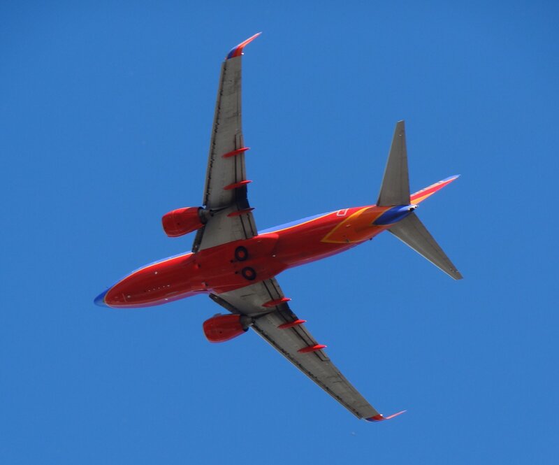 Red Airplane in Flight — Blue