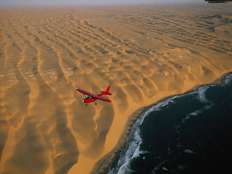 Red Airplane over Desert — Orange
