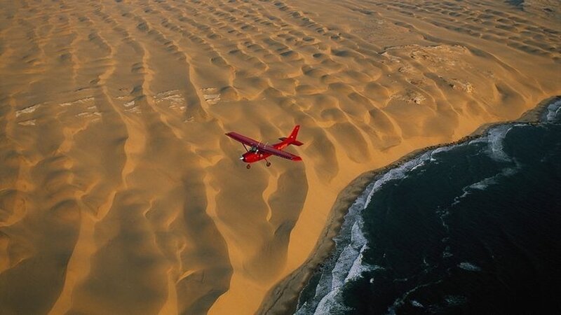 Red Airplane over Desert