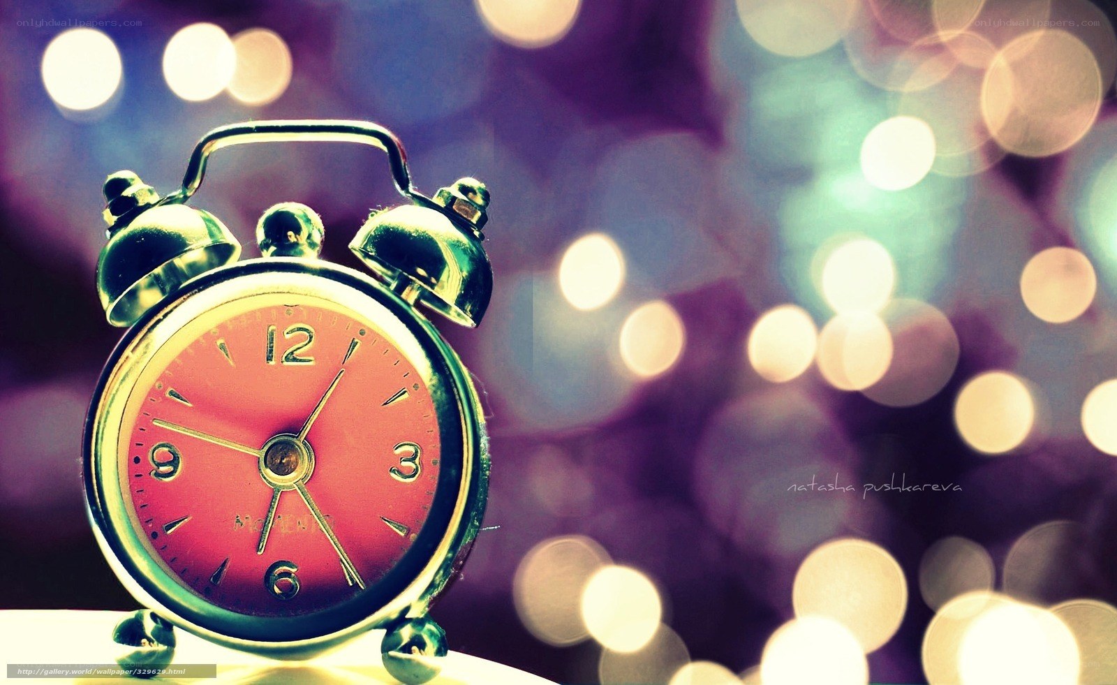 Red alarm clock with bokeh lights