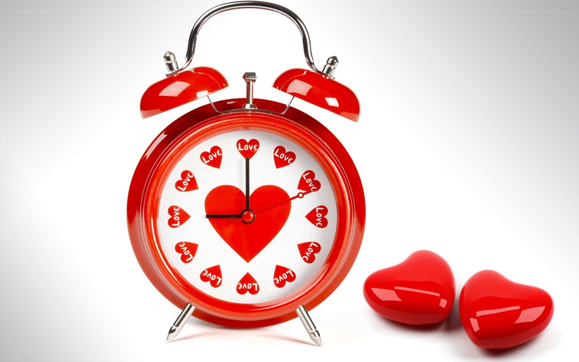 red alarm clock with hearts