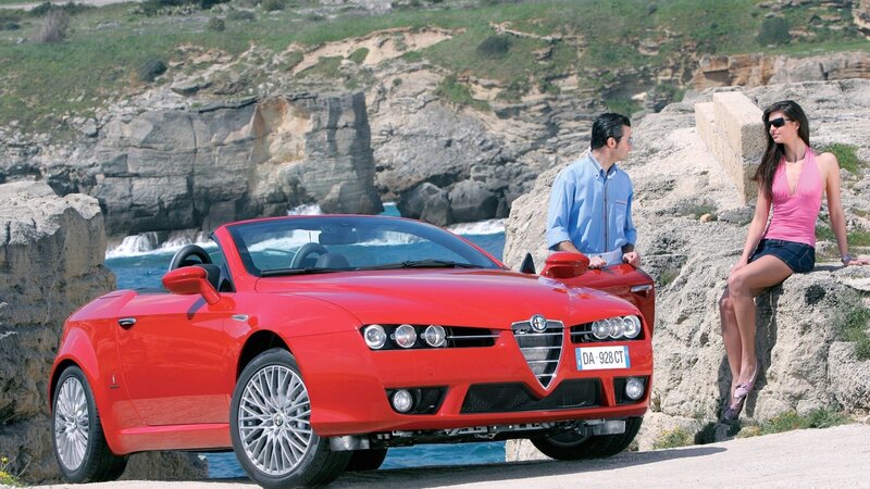 Red Alfa Romeo convertible by the sea