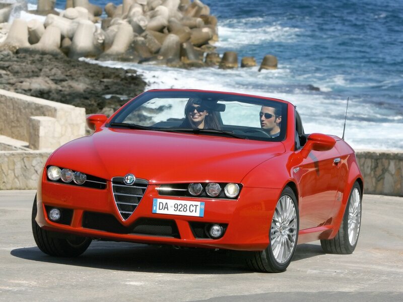 Red Alfa Romeo convertible on coast