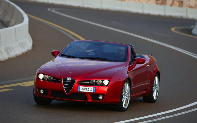 red alfa romeo convertible on road