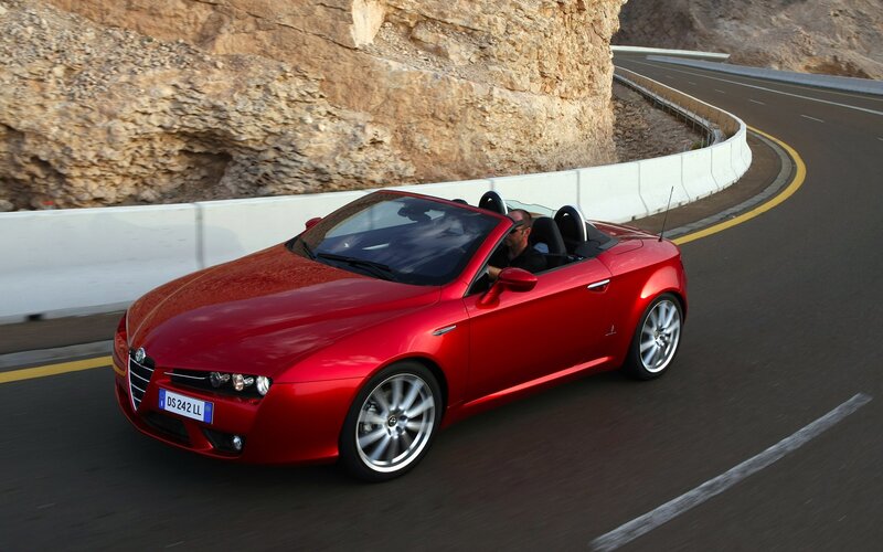 Red Alfa Romeo convertible on road
