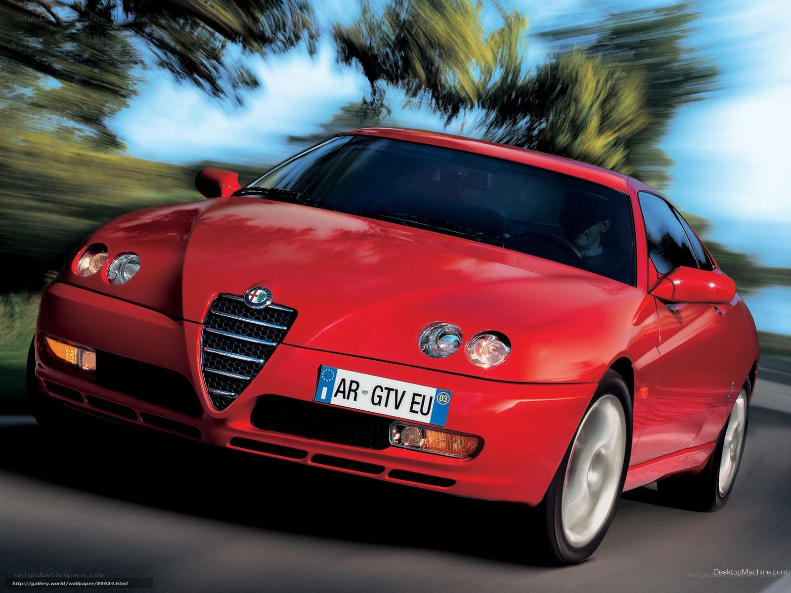 red alfa romeo driving on road