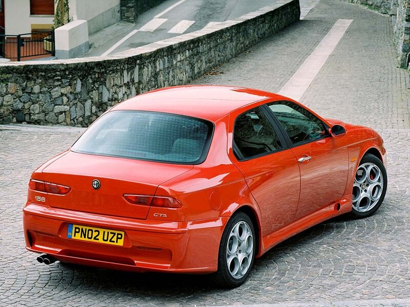 Red Alfa Romeo GTAm parked on cobblestones