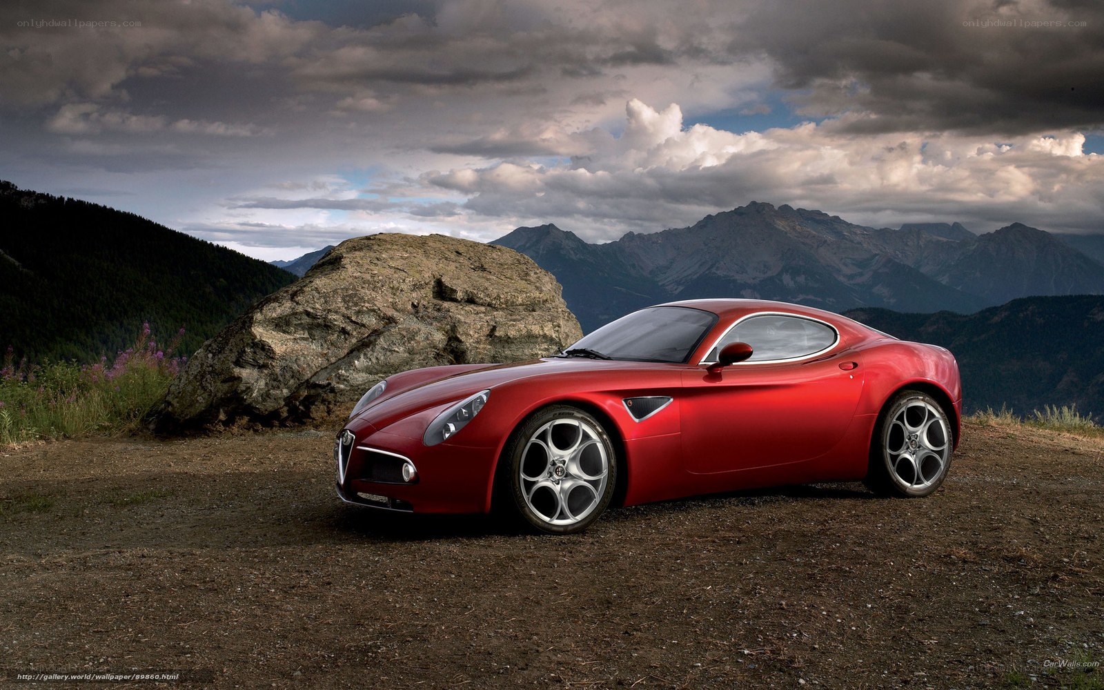 Red Alfa Romeo in mountain landscape