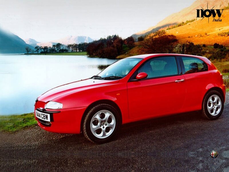 Red Alfa Romeo on lakeside road