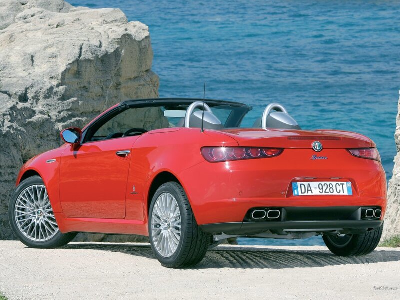 Red Alfa Romeo Spider by the sea