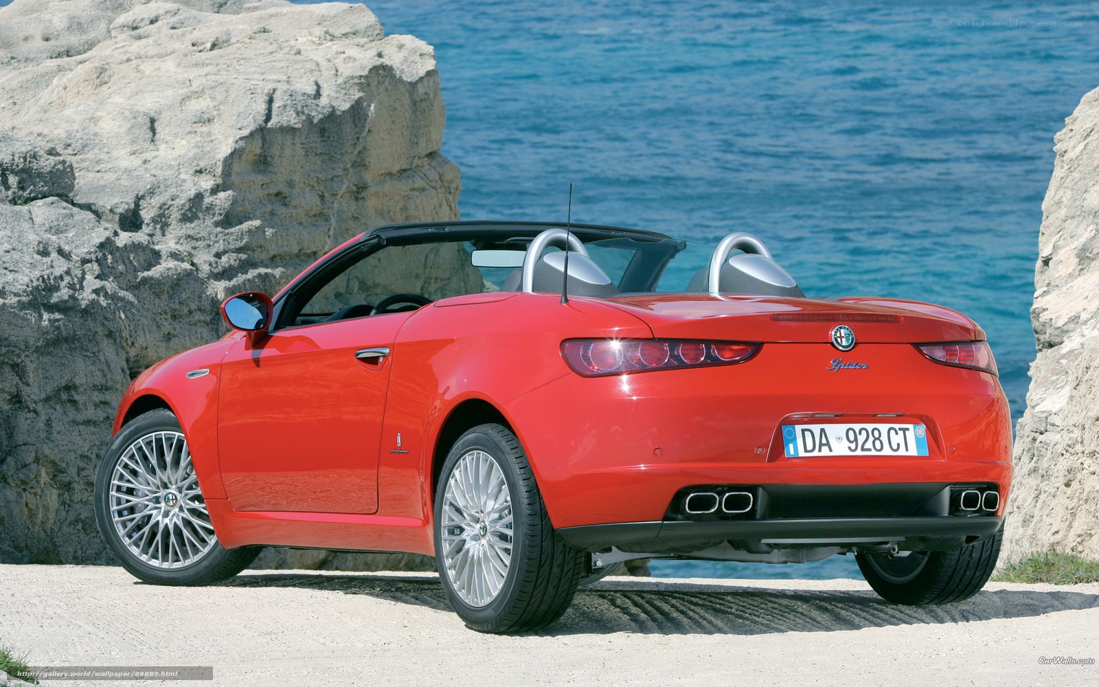 Red Alfa Romeo Spider by the sea