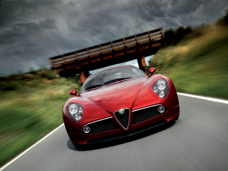 Red Alfa Romeo sports car on road