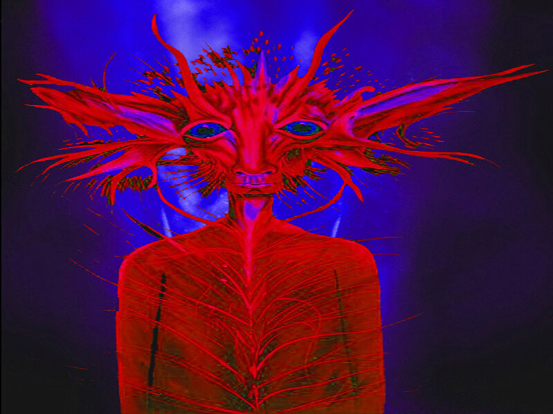 red alien figure with blue eyes