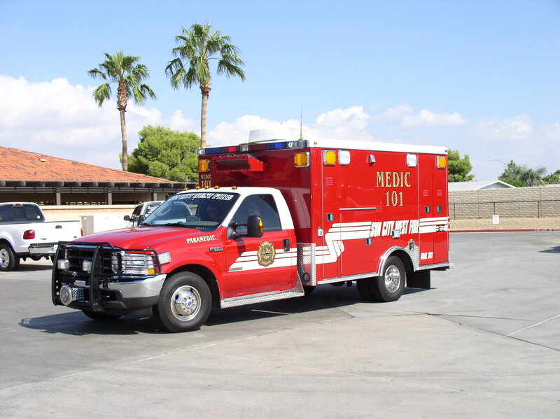 Red ambulance parked in lot