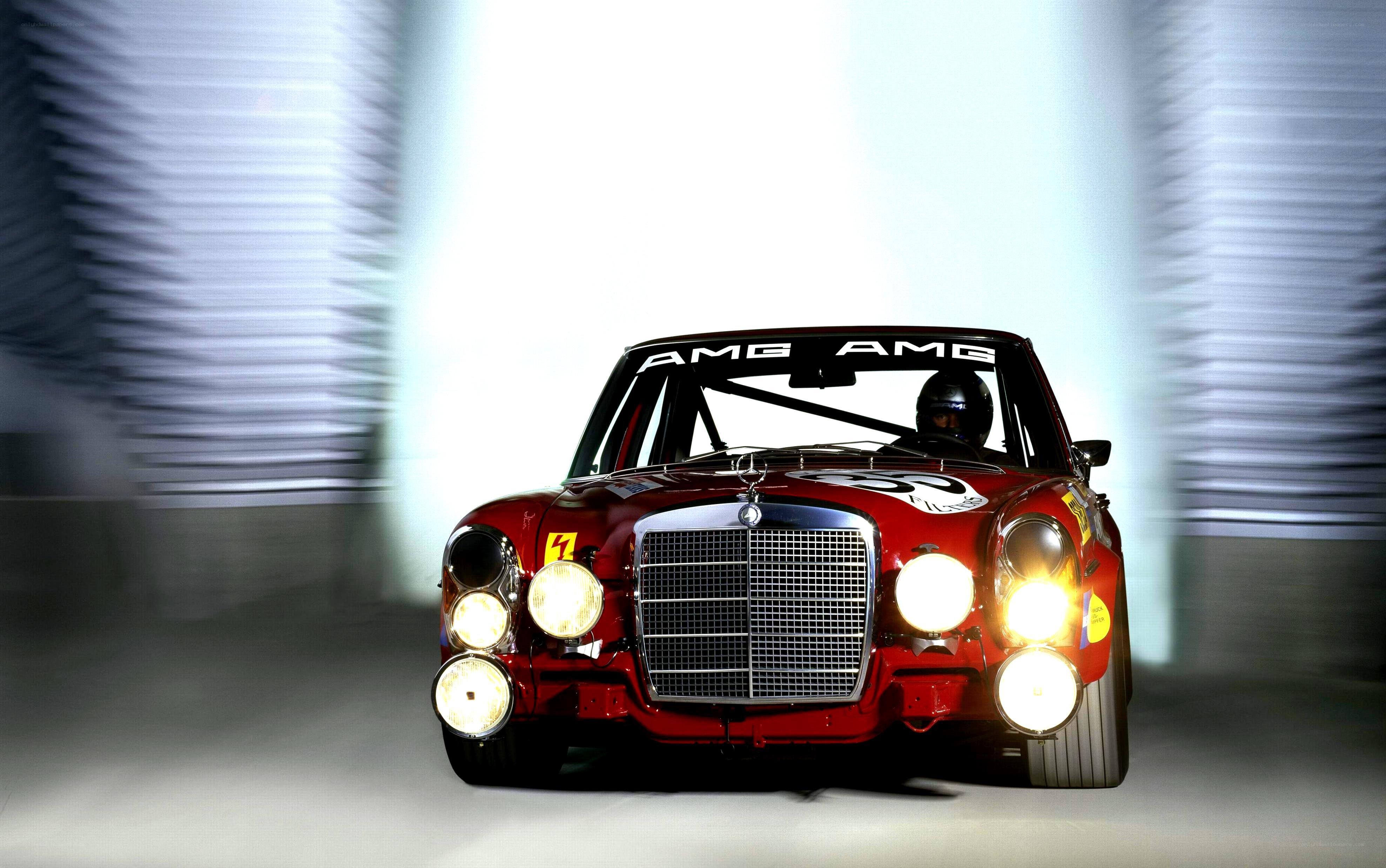 Red AMG race car in motion
